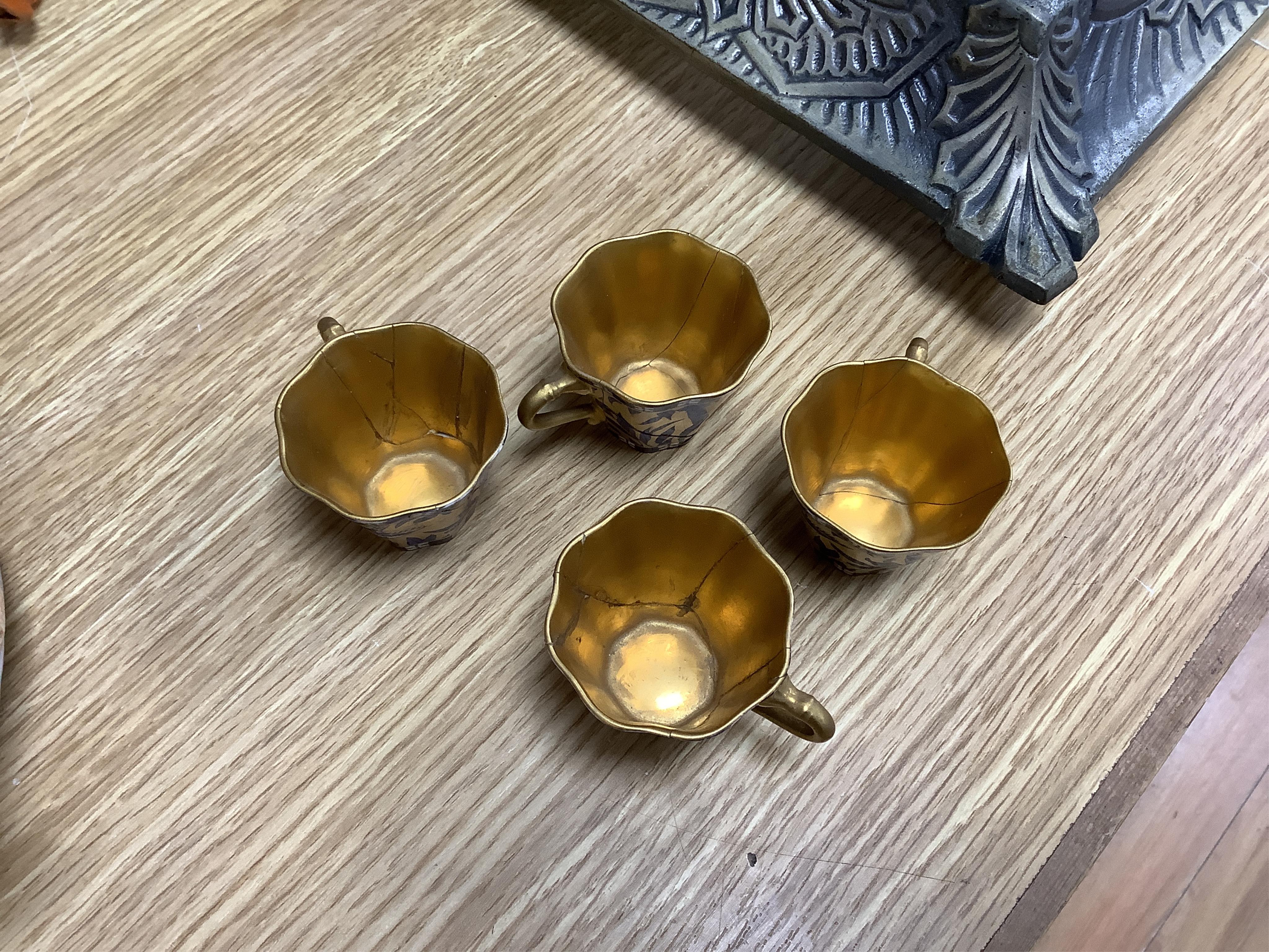 A set of six Coalport blue, gilt and white octagonal coffee cups and saucers, (three cups cracked), and two modern Coalport “Caughley Mask’’ jugs, (14), tallest 14.5cm. Condition - varies